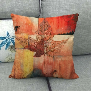 Detailed texture of linen cushion cover featuring an artistic autumn maple leaf print