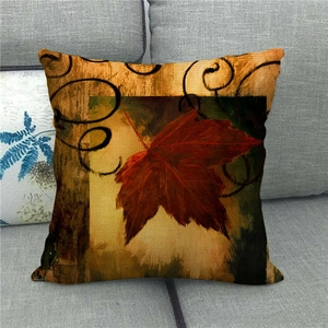 Detailed texture of autumn maple leaf linen pillow cover on a grey sofa set