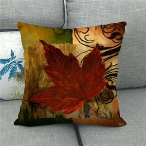 Macro shot of maple leaf oil painting pattern on a textured linen autumn cushion cover