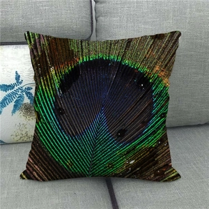 Peacock feather pattern throw pillow cover on a modern grey fabric sofa