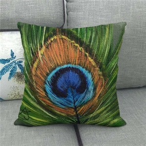Close-up of vibrant peacock feather printed on a textured linen square cushion cover