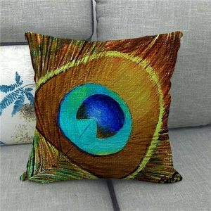 Linen cushion cover with vivid peacock feather eye pattern on a modern grey sofa