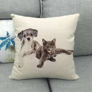 Linen square pillowcase featuring realistic grey cat and dog prints on a cozy sofa