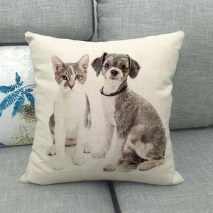 Linen Christmas pillowcase with cat and dog print on a gray sofa for home decor