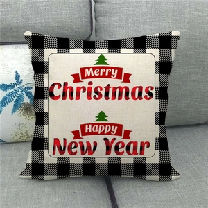 Merry Christmas buffalo plaid linen throw pillow with green tree design on grey sofa