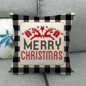 Close-up of linen Christmas pillowcase with buffalo plaid and reindeer on a sofa
