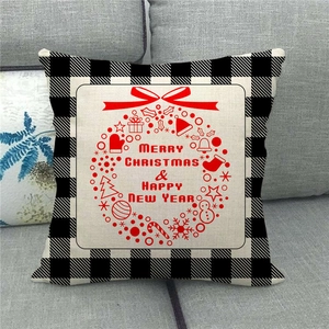 Close-up of linen Christmas pillow cover with buffalo plaid border and festive icons