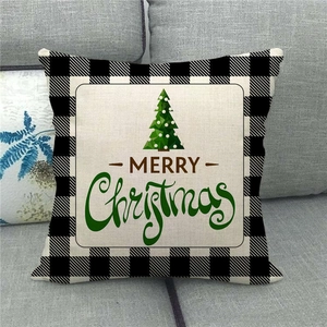 Detail view of Merry Christmas linen pillowcase with buffalo plaid borders and tree motif