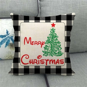 Detail of linen Christmas pillowcase featuring a green tree and buffalo plaid border
