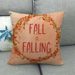 Fall is Falling linen pillow cover with seasonal berry wreath on a gray sofa