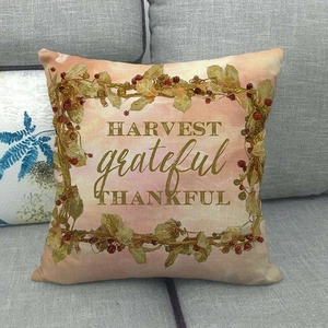 Detail of linen pillow cover with autumn harvest wreath and grateful thankful typography