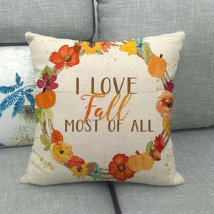 Detail of linen fall pillow cover featuring a pumpkin wreath and seasonal quote text