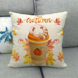 Linen pillowcase with autumn cat, pumpkin and wreath on a grey sofa background