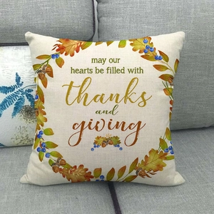 Linen Thanksgiving throw pillow featuring autumn wreath and thankful message on a sofa