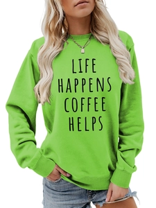 Detail view of the green crewneck sweatshirt featuring black LIFE HAPPENS COFFEE HELPS print