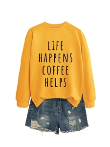 Detail of yellow sweatshirt with Life Happens Coffee Helps print and ripped denim shorts