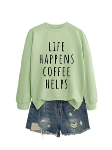 Flat lay of a mint green sweatshirt with Life Happens Coffee Helps text and denim shorts