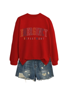 Flat lay of red long-sleeve sweatshirt with colorful text and distressed denim shorts