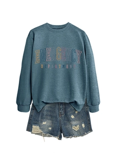 Detail of blue crewneck sweatshirt with emergency department print and denim shorts