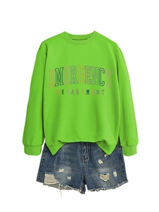 Detail of neon green sweatshirt with emergency department print and ripped denim shorts