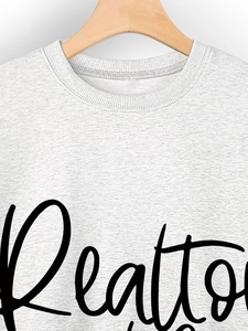 Detail of ribbed neckline and black Realtor print on grey cotton sweatshirt