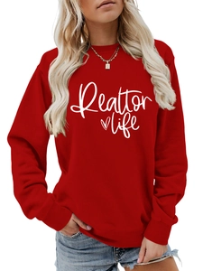 Detail of red Realtor Life sweatshirt with white heart print and golden necklace