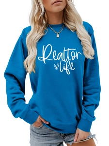 Detail of royal blue Realtor Life sweatshirt showing white heart print and ribbed cuffs