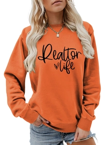 Detail of Realtor life heart print on soft orange crewneck sweatshirt fabric