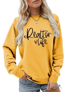 Detail of bright yellow crewneck sweatshirt with Realtor Life black script lettering