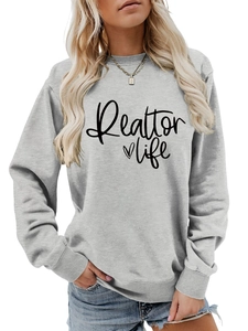 Detail of Realtor Life print and heart on a grey long sleeve crewneck sweatshirt