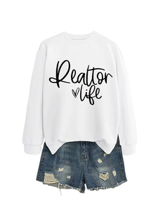 Close-up of Realtor Life heart graphic on white long-sleeve crewneck sweatshirt
