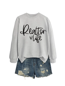 Detail of grey Realtor Life sweatshirt with heart print and distressed denim shorts