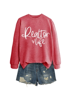 Close-up of red crewneck sweatshirt with Realtor Life print and distressed denim shorts