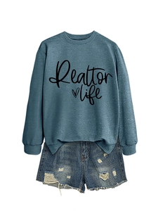 Flat lay of Realtor Life blue sweatshirt with denim shorts and distressed fringe detail