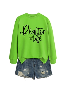 Flat lay of neon green Realtor life sweatshirt paired with distressed blue denim shorts