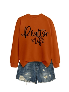 Detail of rust red Realtor life sweatshirt paired with distressed blue denim shorts