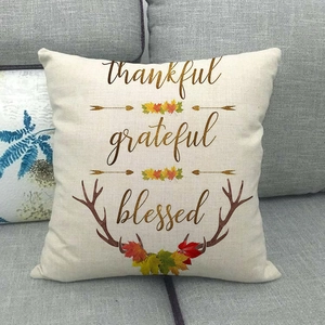 Detailed close-up of linen pillow cover with thankful grateful blessed festive autumn print