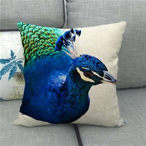 Linen cushion cover with high-definition peacock head print on a modern grey sofa