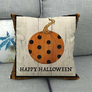 Detail of linen Halloween pillow cover with orange pumpkin and Happy Halloween text