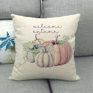 Close-up of linen pillow cover with watercolor pumpkin and welcome autumn text