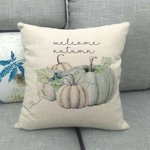 Close-up of linen pillow cover with watercolor pumpkins and welcome autumn text