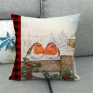 Close-up of linen Christmas pillow cover featuring watercolor robins on a snowy fence