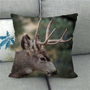 Housse de coussin en lin avec imprimé cerf réaliste sur un canapé gris moderne