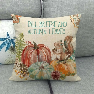 Fall themed linen pillow cover featuring pumpkin and squirrel on a grey sofa