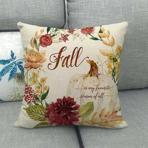 Detail of linen autumn pillow case with white pumpkin and fall seasonal flower patterns