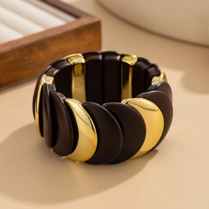 Detail of chunky stretch bracelet with alternating dark brown matte and gold metal segments