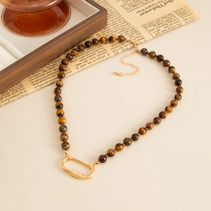 Vintage tiger eye stone beaded necklace featuring a gold carabiner clasp on a retro background