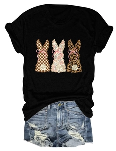 Detail of bunny silhouettes with plaid floral and leopard patterns on a black t-shirt
