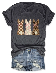 Detail of dark grey T-shirt featuring three decorative rabbits with denim shorts