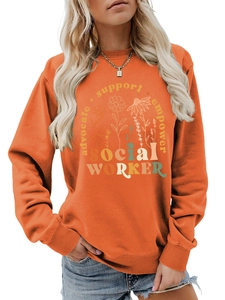 Detail view of the floral graphic and social worker typography on an orange sweatshirt